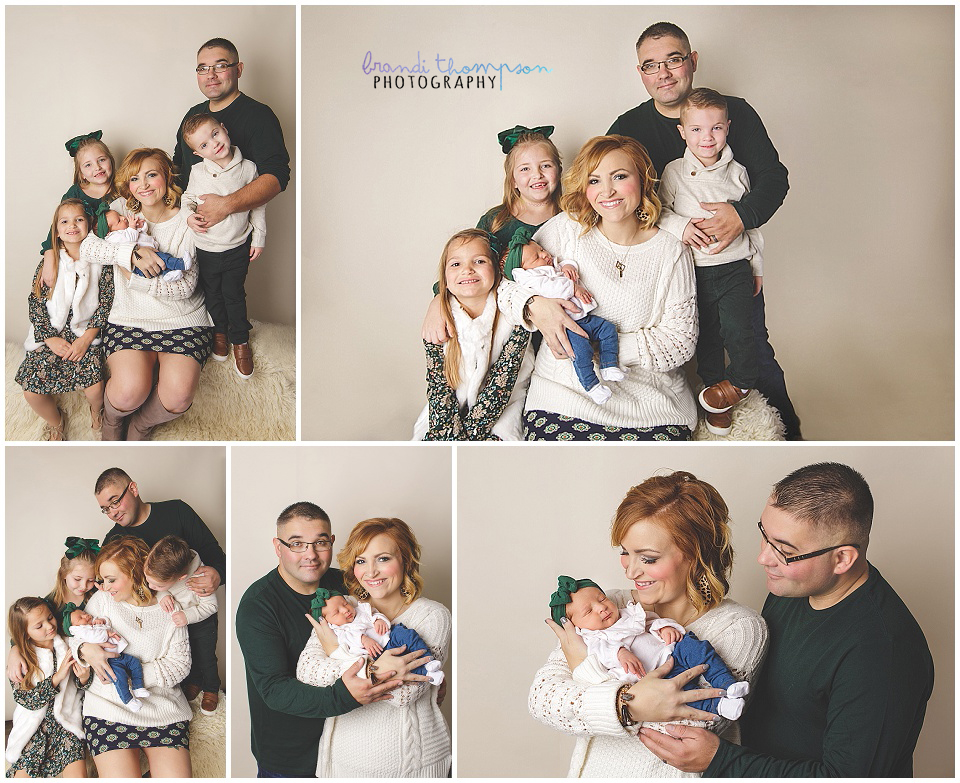 newborn baby girl with family in plano studio on beige background